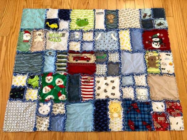 Custom Memory Quilt with raggedy frayed edges made out of baby clothes.