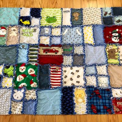Custom Memory Quilt with raggedy frayed edges made out of baby clothes.